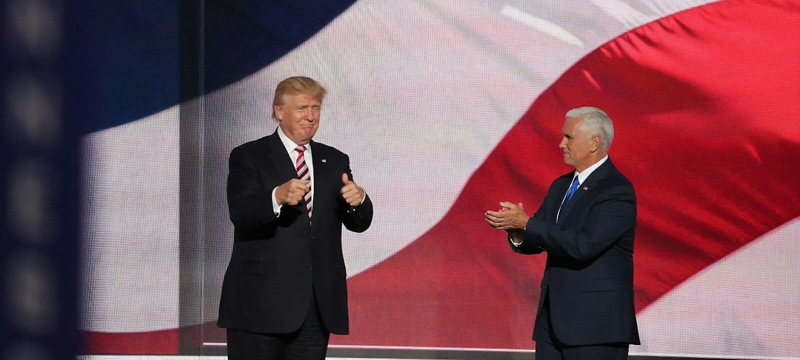 Donald Trump beside man in black suit