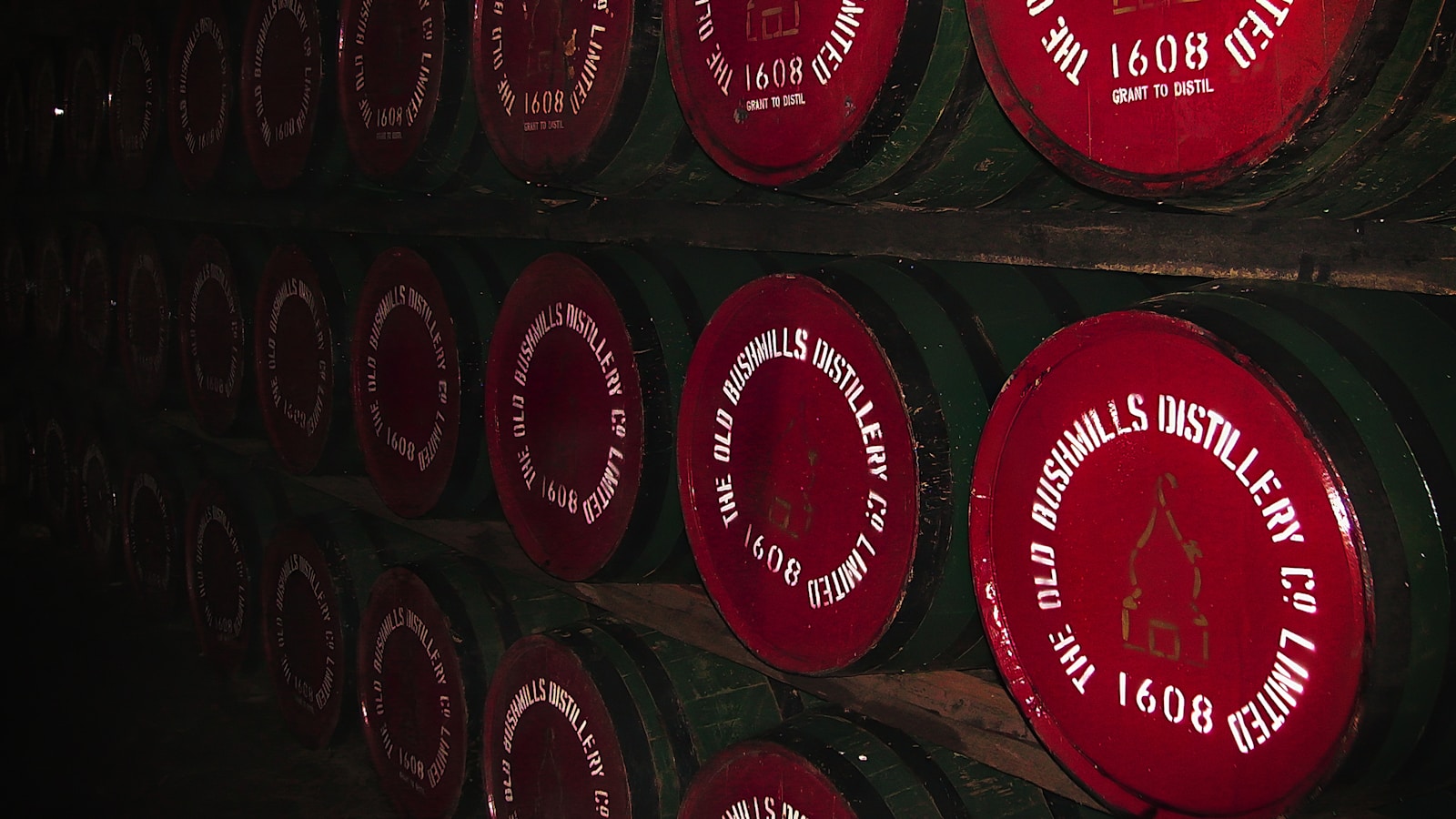 a row of wine barrels with labels on them